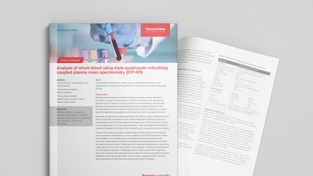 A blood sample in a tube held by a hand wearing lab PPE  