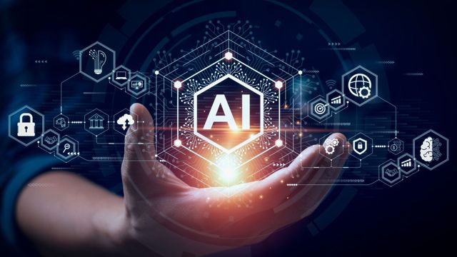 AI icon illuminated in individual hand, surrounded by other digital icons. 
