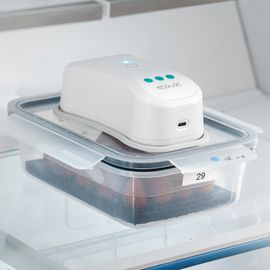 Plastic sealable food container with food in on top of which is a device for killing microorganisms with UV light. 
