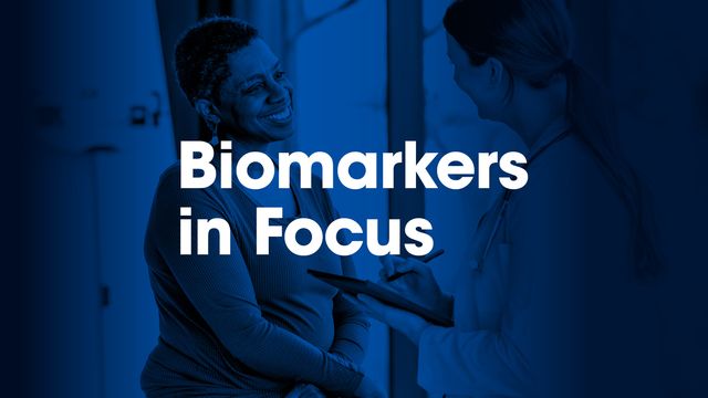 A patient talking to a doctor as part of a clinical trial with the words Biomarkers in Focus displayed overhead. 