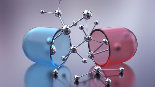 A red and blue drug pill split down the middle with a model of a molecule coming out. 