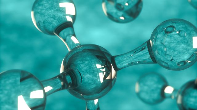 A digital illustration of a molecule, made out of a glass-like material. 